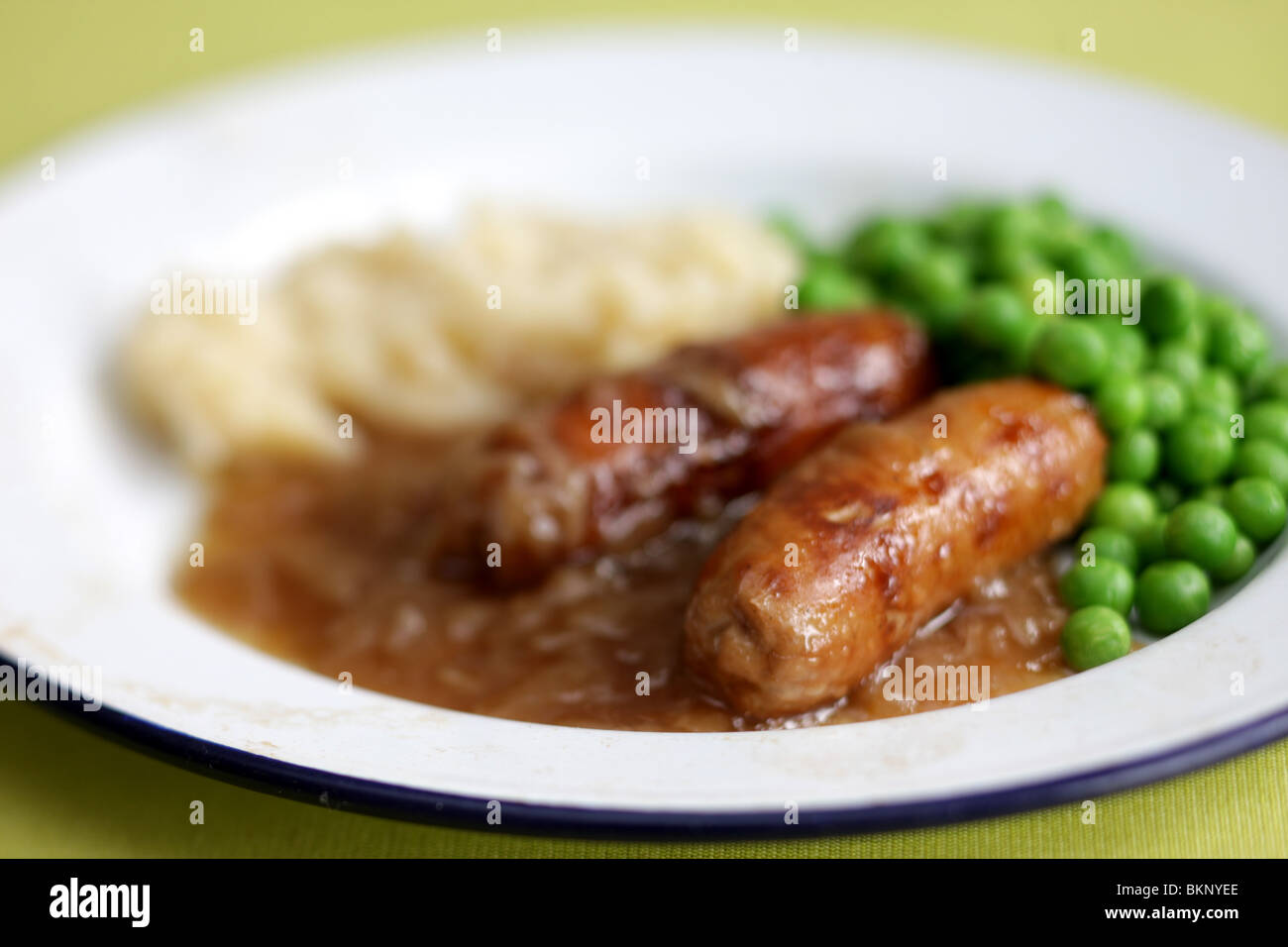 Freshly Cooked And Prepared Meal Of Sausage And Mash With Peas and Gravy And No People Stock Photo