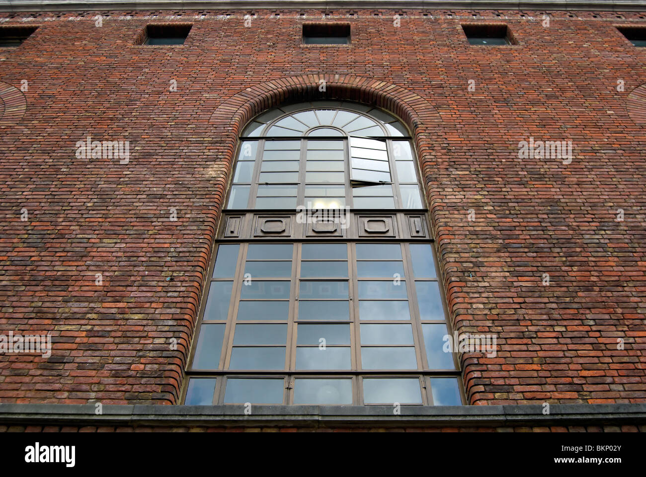 window in redbrick wall on the west side of hammersmith town hall, london, england Stock Photo