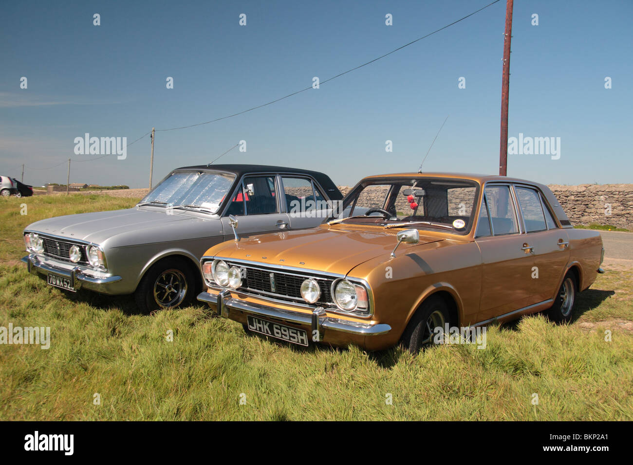Two 4 door Ford Cortina Mark II classic cars parked close to the Hook  lighthouse on the Hook Penisula, Wexford, Ireland Stock Photo - Alamy