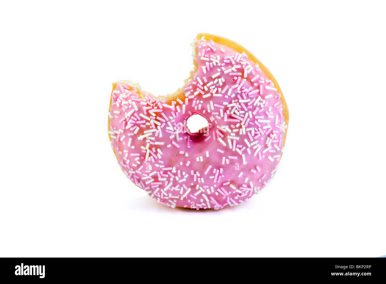 strawberry flavored doughnut with a bite taken out isolated on white Stock Photo