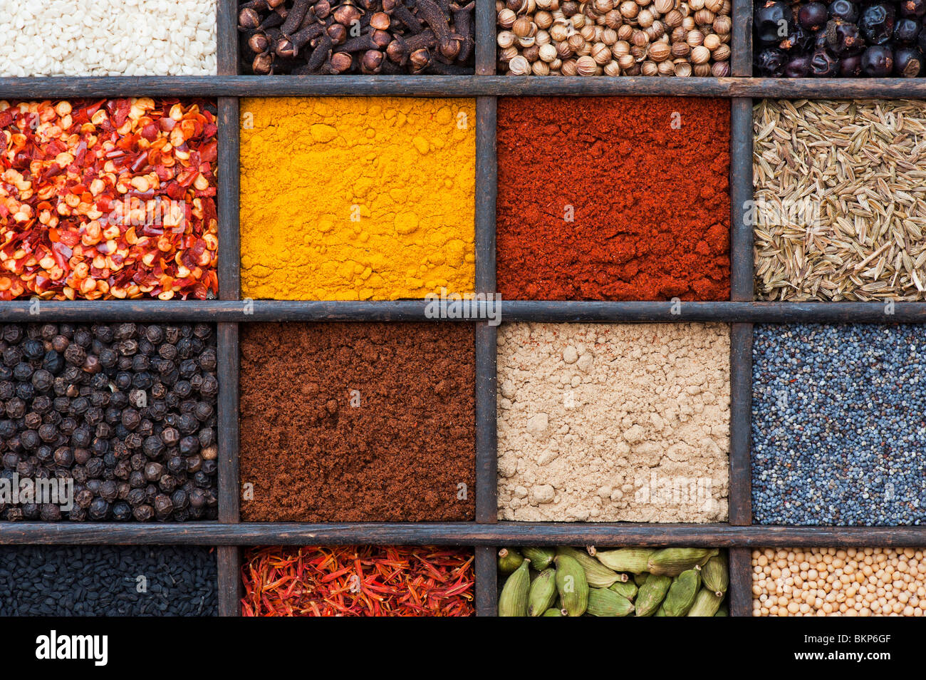 Indian spices in an old wooden tray. Flat lay photography from above Stock Photo