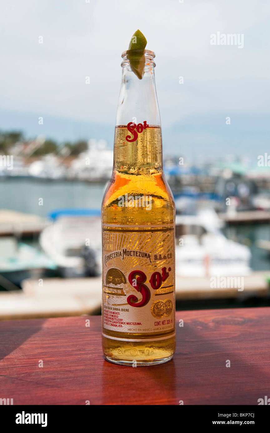 Bottle of Mexican Beer against the Backdrop of Cabo San Lucas Marina