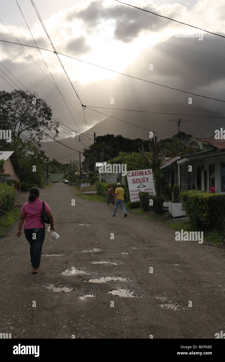 Costa Rican woman walking towards Volcano Arenal. Stock Photo