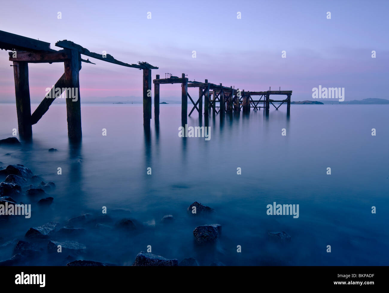 Aberdour pier in predawn light. The pier is abandoned and derelict now. Stock Photo