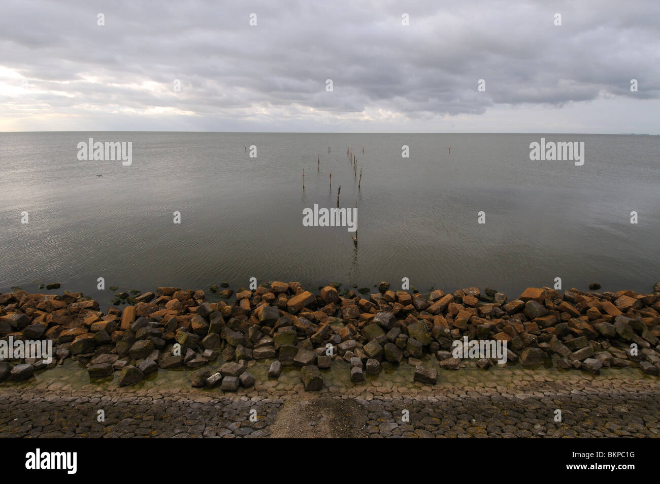 Dike, rocks, calm water and clouds above IJsselmeer Stock Photo - Alamy