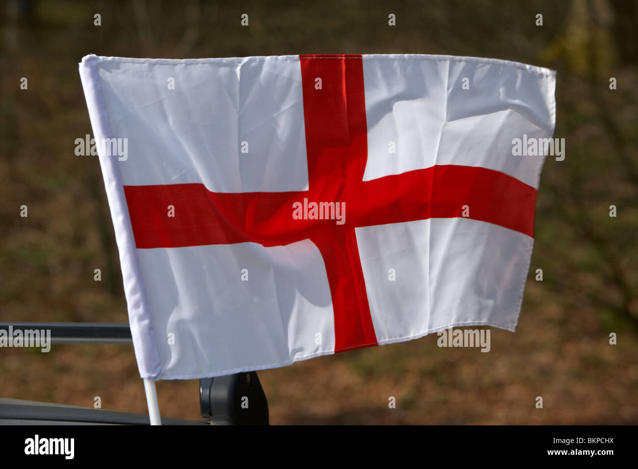 mini cross of St George english national flag flying on a car on st georges day england uk Stock Photo