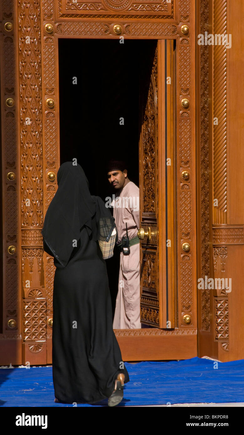 Muslim woman entering Sultan's Qaboos mosque Muscat Oman Stock Photo