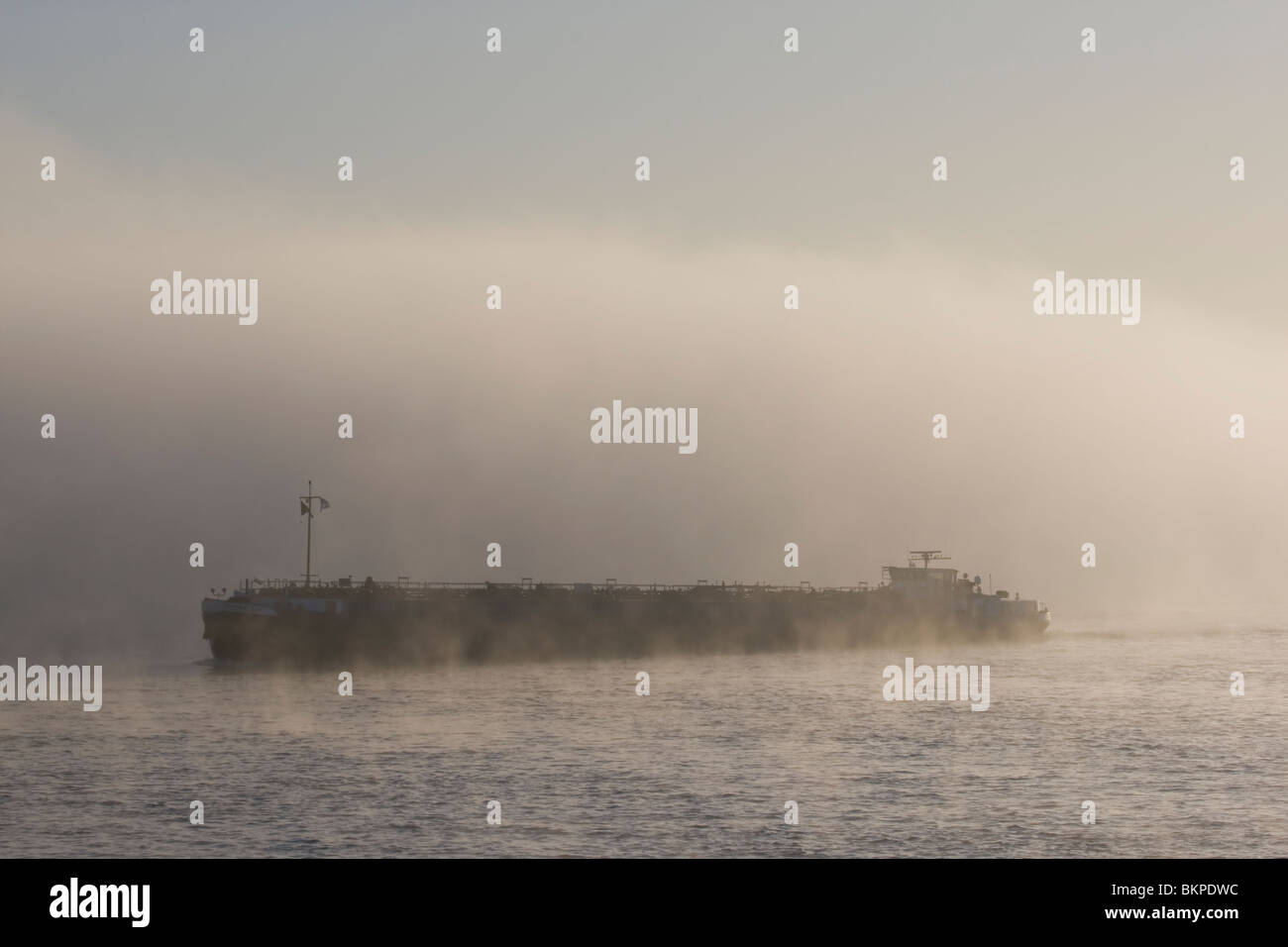 Sfeervolle mistige vroege morgen aan de Waal bij Nijmegen met rijnaak, Scenic eary morning at the Waal with fog and boat Stock Photo