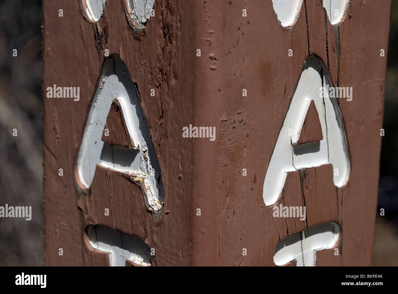 Informational wooden signpost (denoting the location of a water spigot) from with the letters A clearly incised on two sides. Stock Photo