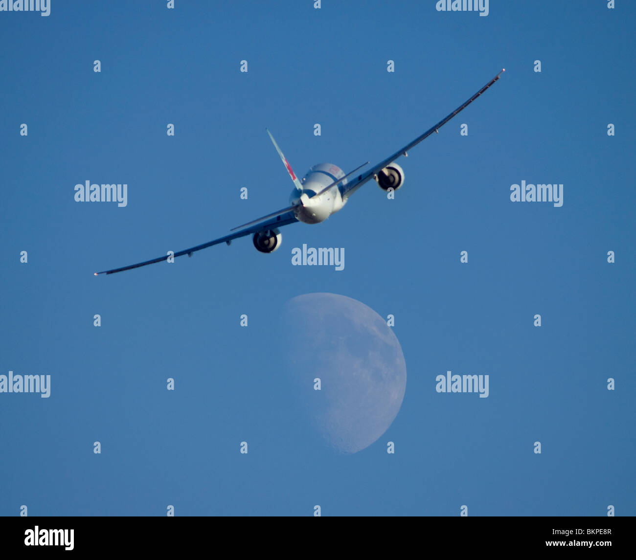 C-FRAM Air Canada Boeing 777-333ER in flight with the moon in the background. Stock Photo
