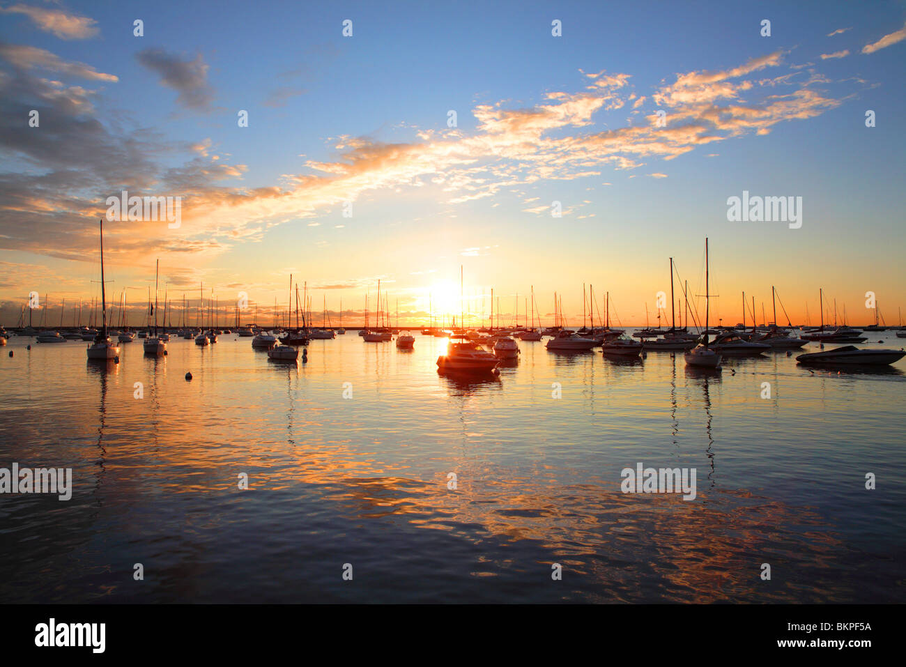 BOATS AT SUNRISE IN MONROE HARBOR IN DOWNTOWN CHICAGO, ILLINOIS, USA  Stock Photo