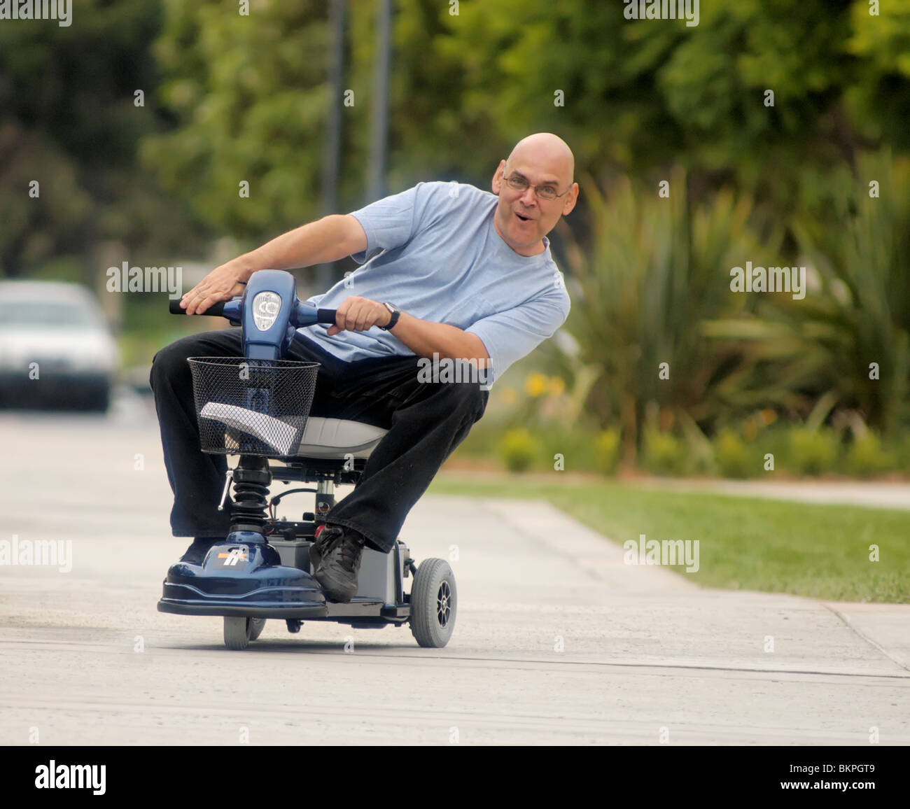 Stock photograph of a man leaning into a turn while riding a motorized
