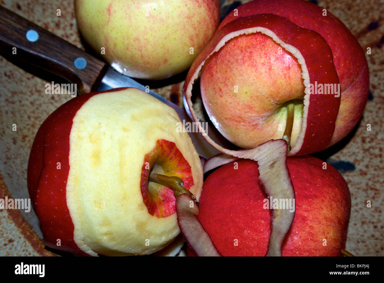 Peeling Gala apples for cooking Stock Photo Alamy