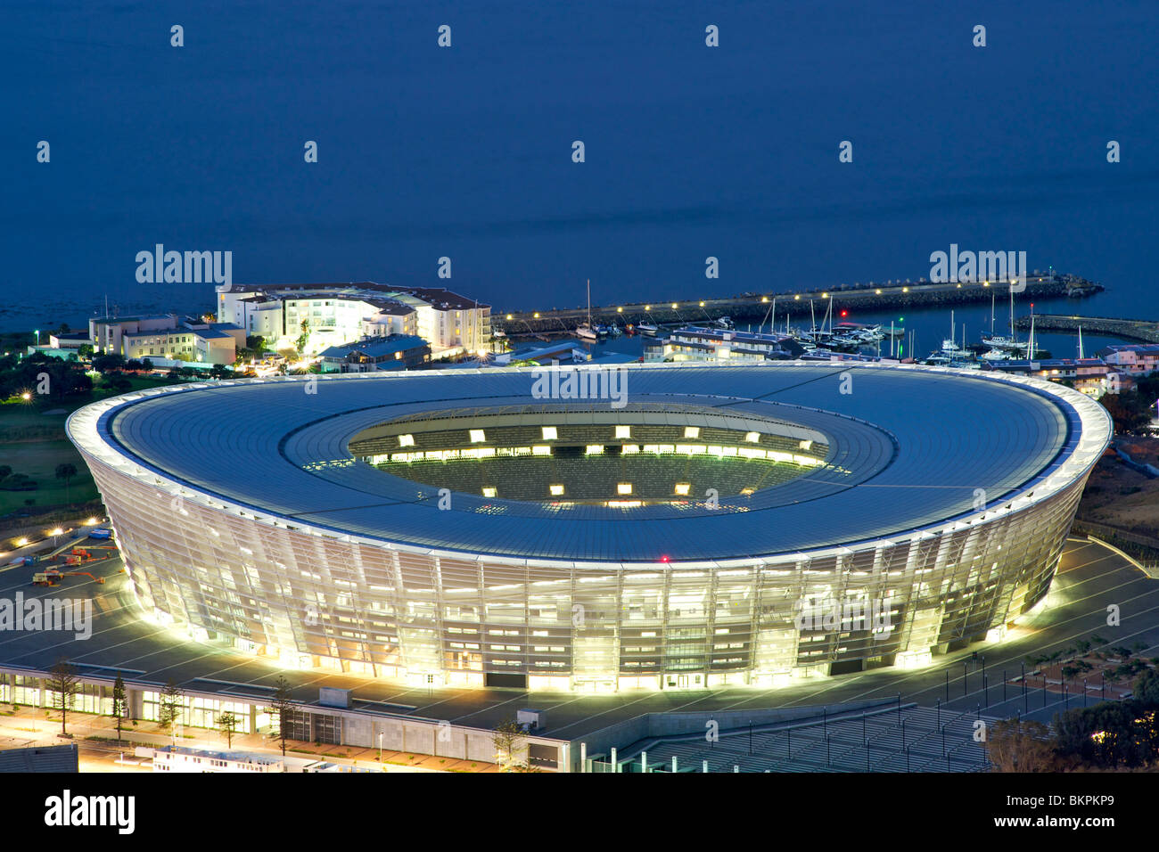 Dusk view of the new FIFA 2010 stadium in Green Point, Cape Town with Table Bay in the background. Stock Photo
