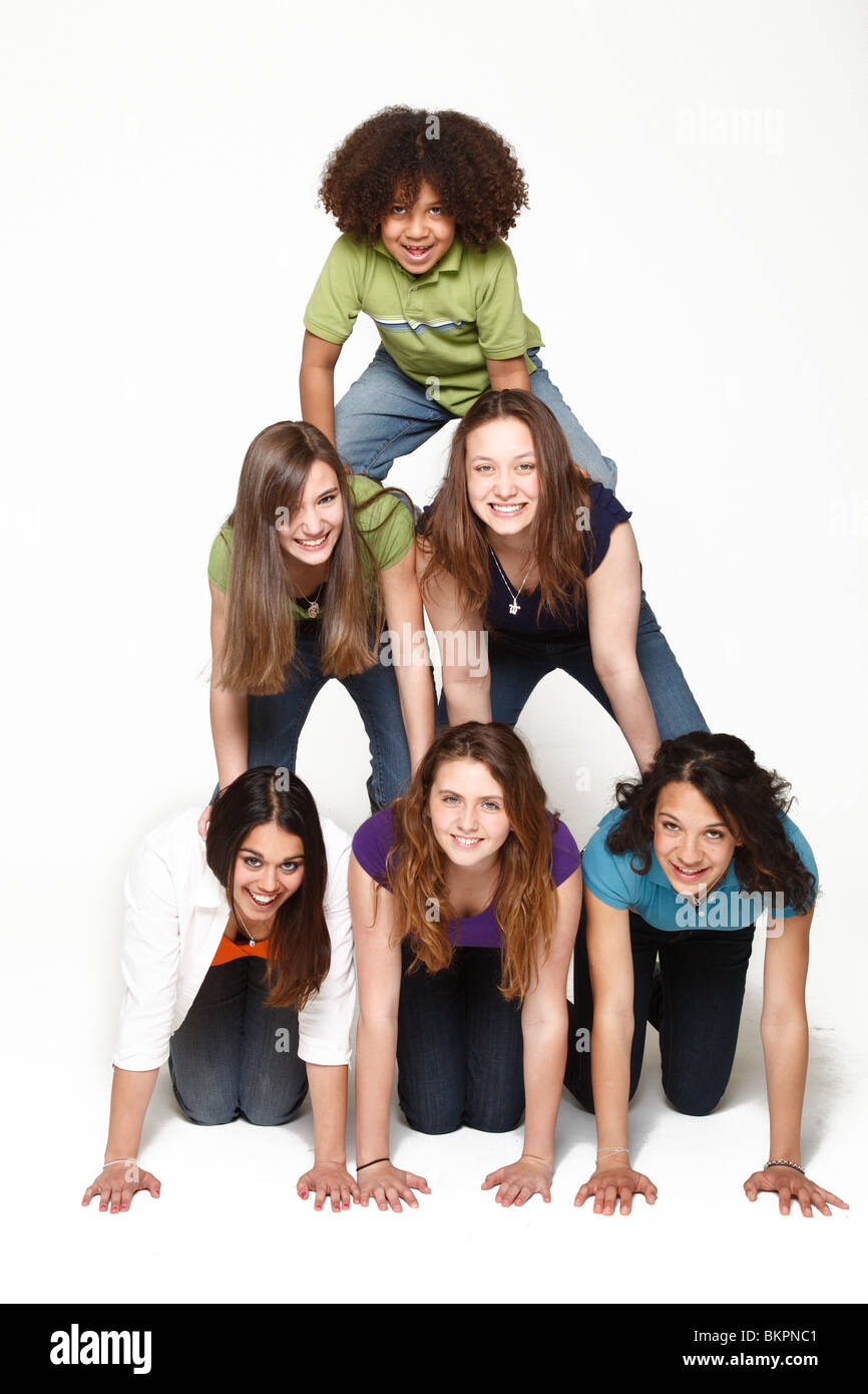 Six happy kids forming a pyramid Stock Photo