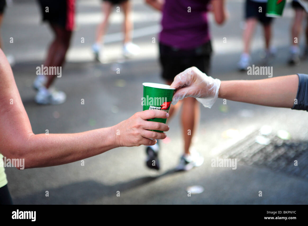 CHICAGO MARATHON ; ONE OF THE CHICAGO MARATHON STAFF MEMBERS HANDING A CUP OF ENERGY DRINK TO A RUNNER Stock Photo