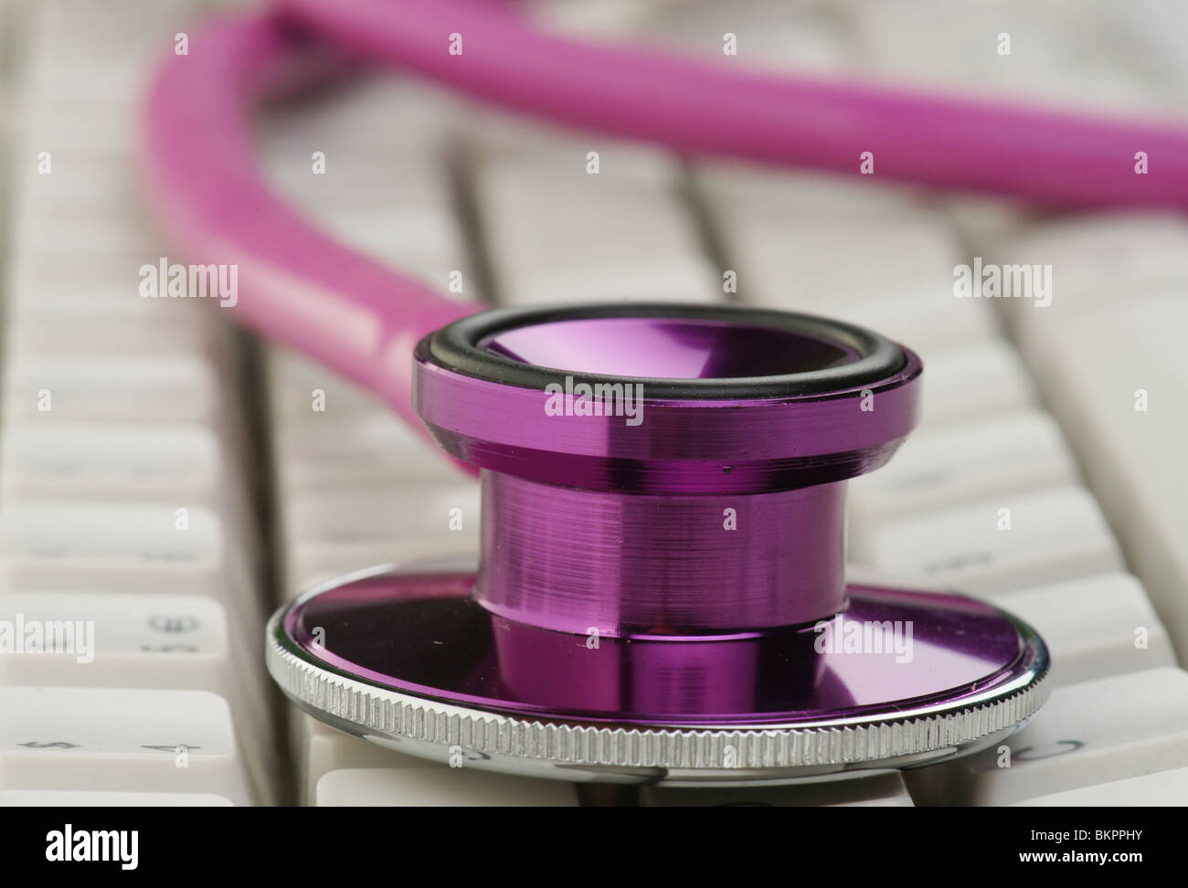 pink stethoscope on a computer keyboard Stock Photo