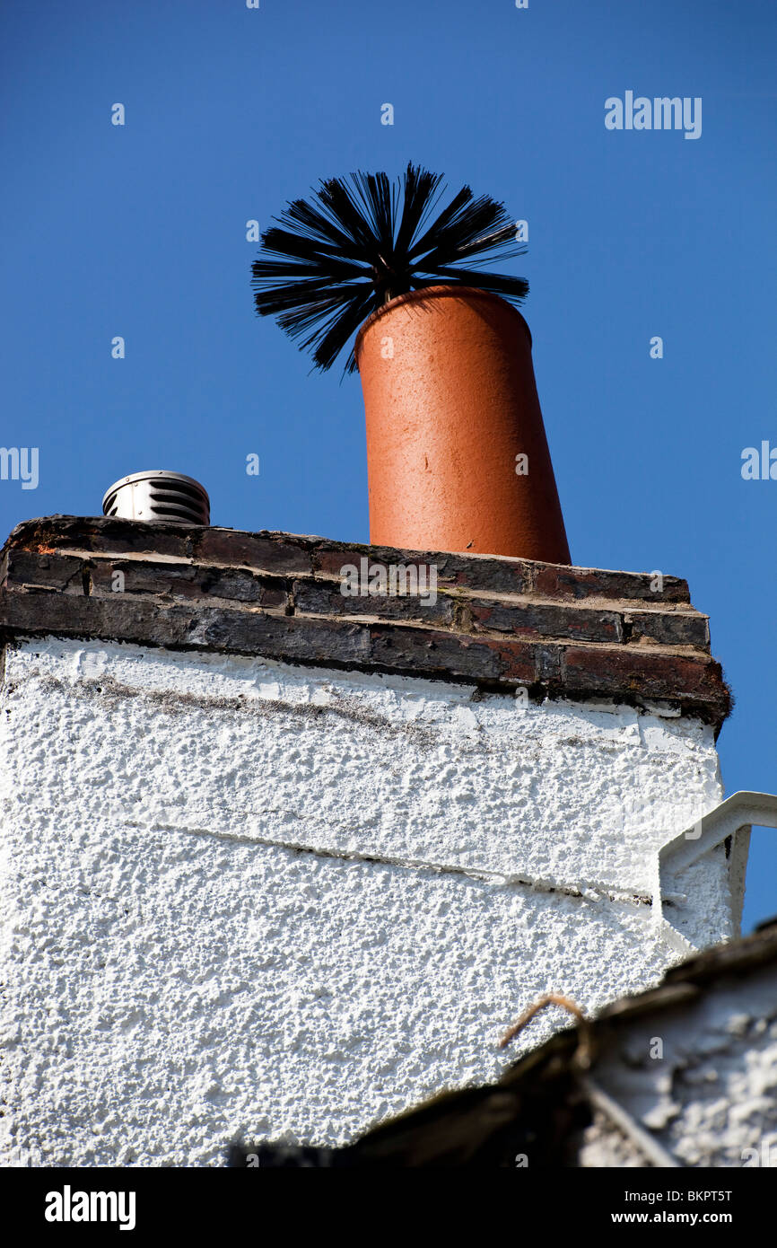 Chimney cleaning brush poking out of chimney pot Stock Photo Alamy