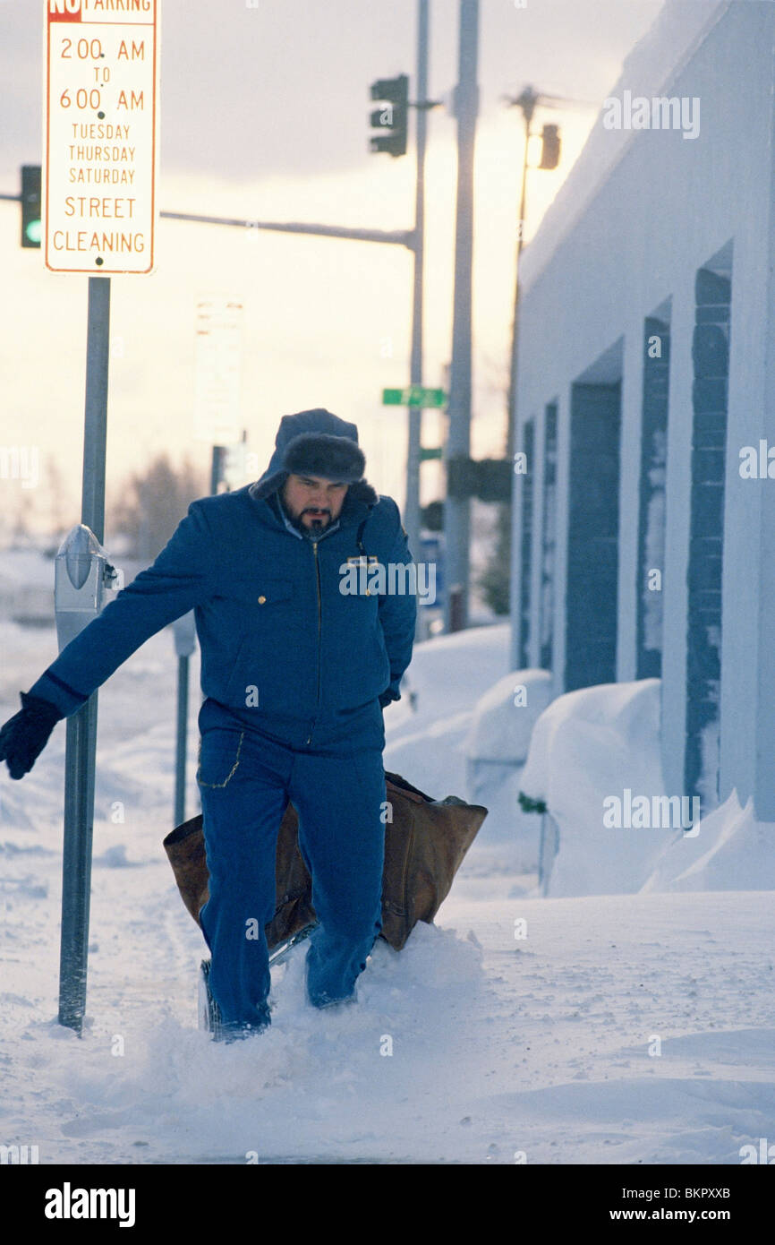 Mailman Delivers Mail in Downtown Anchorage Winter AK Stock Photo