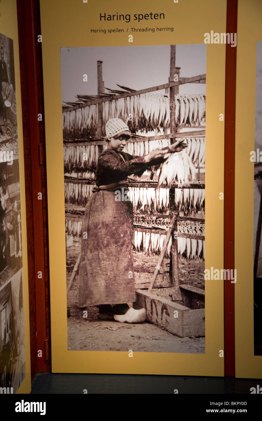 Old photo of girl threading herring fish, Zuiderzee museum, Enkhuizen, Netherlands Stock Photo
