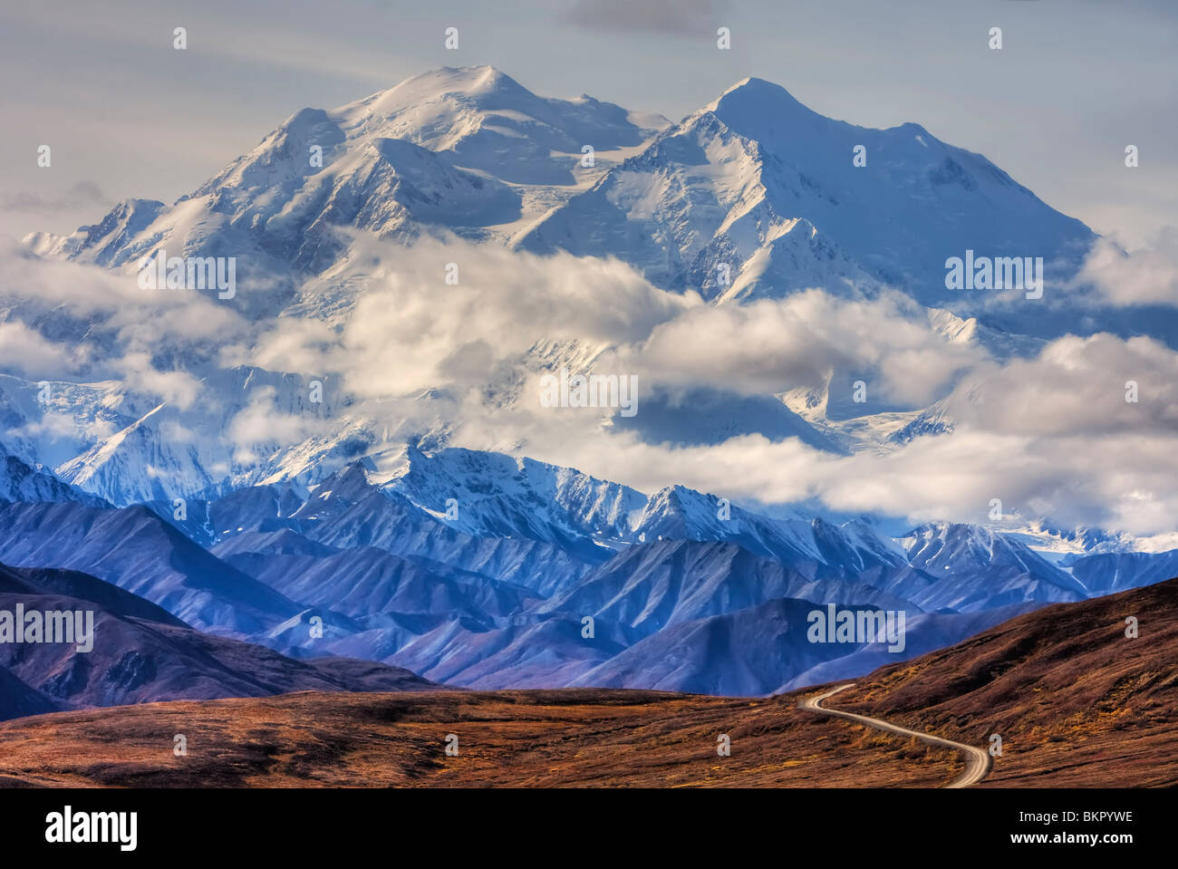 Scenic view of Mt. McKinley with colorful Autumn tundra and the park road in the foreground, Denali National Park, Alaska Stock Photo