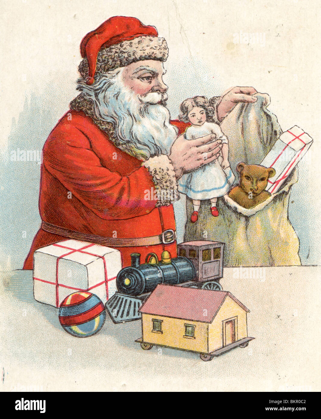 Father Christmas Filling his Sack with Toys Stock Photo