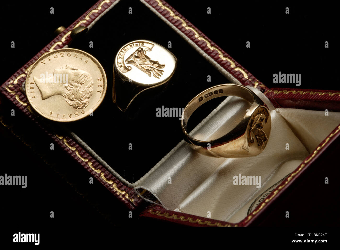 Two gold Signet rings and a Victorian half gold sovereign Stock Photo