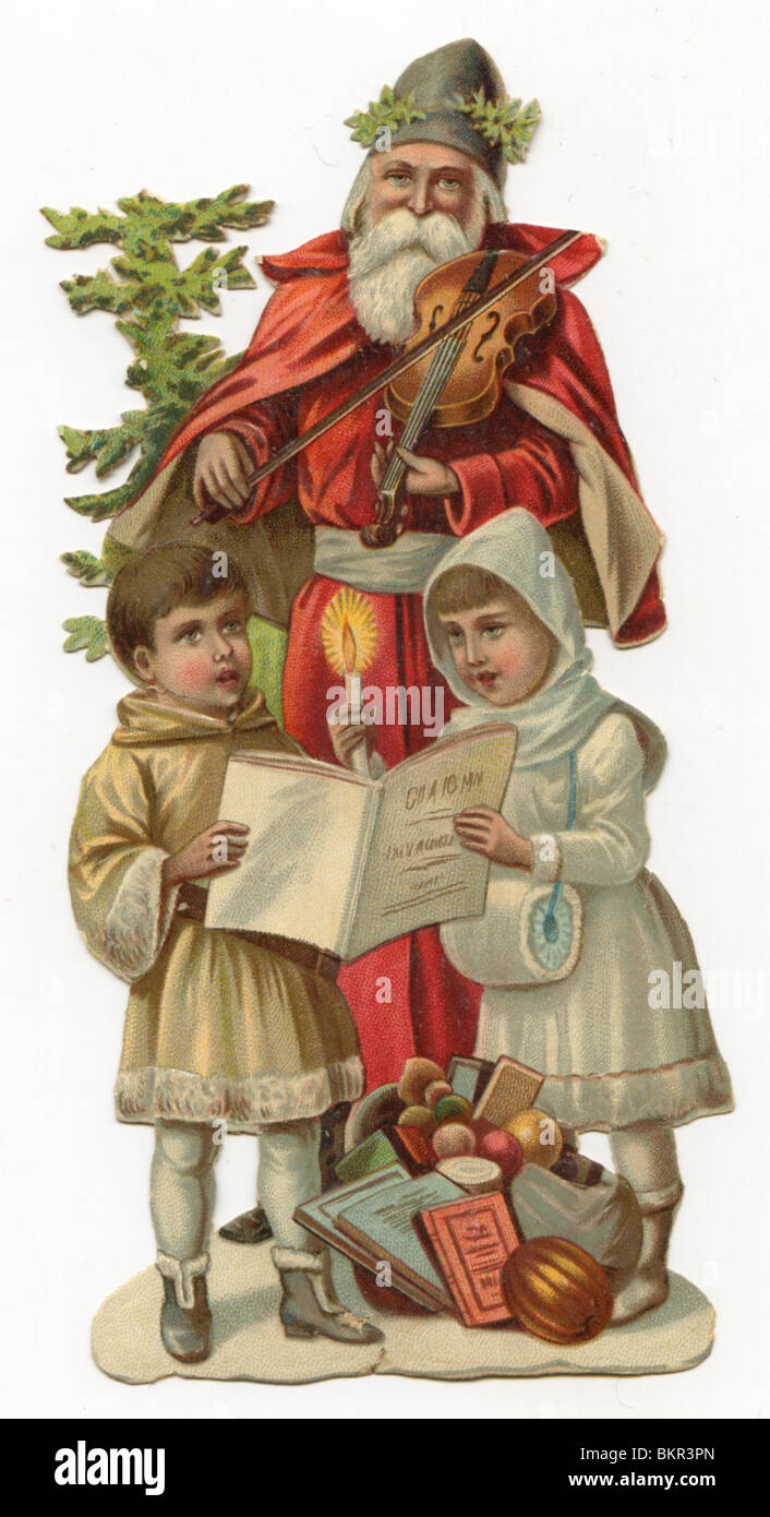 Father Christmas with Two Carol Si ngers Stock Photo