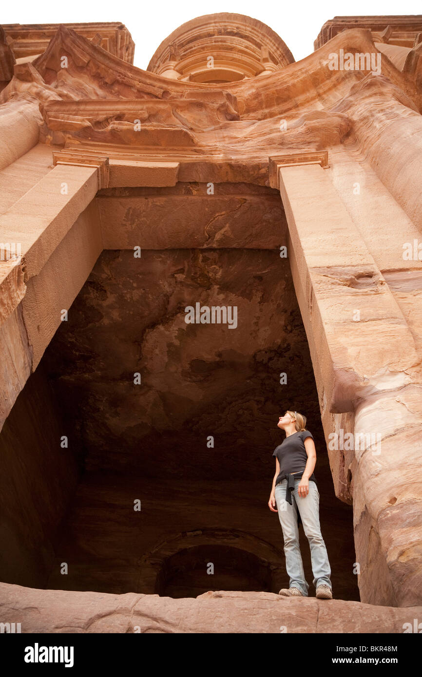 Jordan, Petra. A tourist is dwarfed in the doorway of El Deir (The Monastery) MR Stock Photo