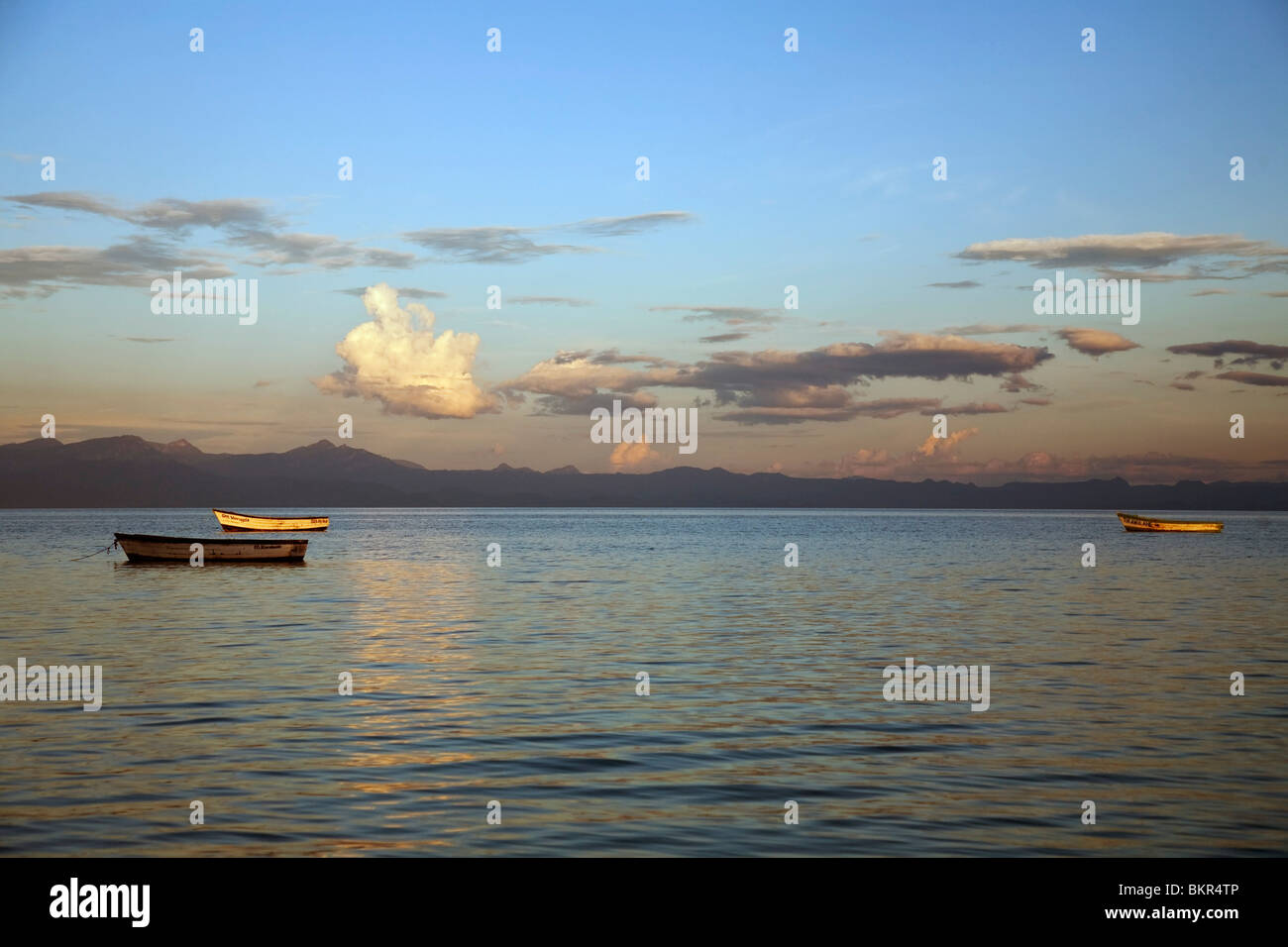 Malawi, Monkey Bay. Boats on the calm waters of Lake Malawi at sunset