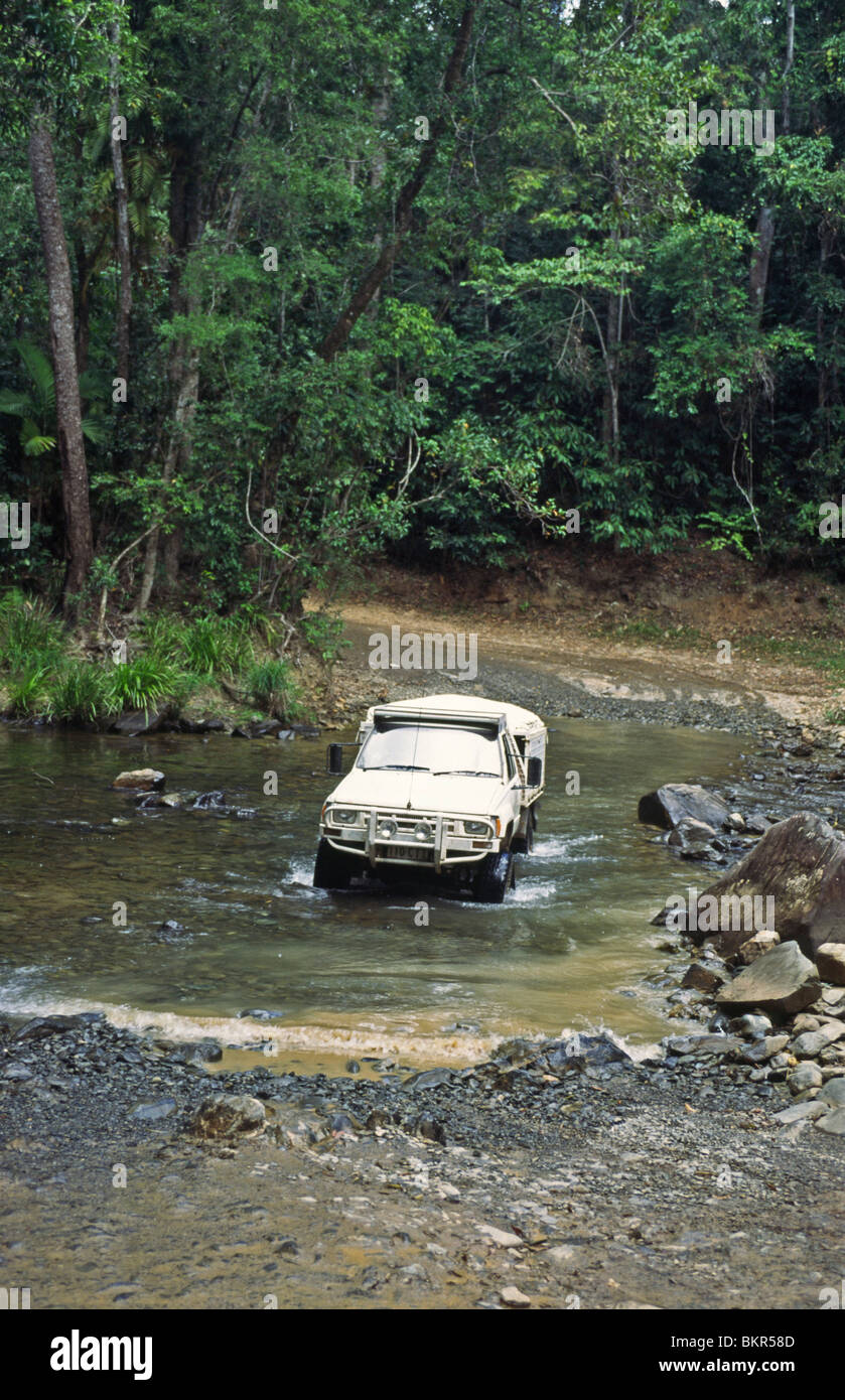A 4WD pickup vehicle crossing a creek, Daintree National Park, Queensland Australia Stock Photo