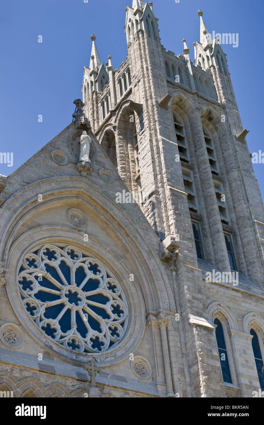 Looking up at a church with stained glass window, located in Guelph