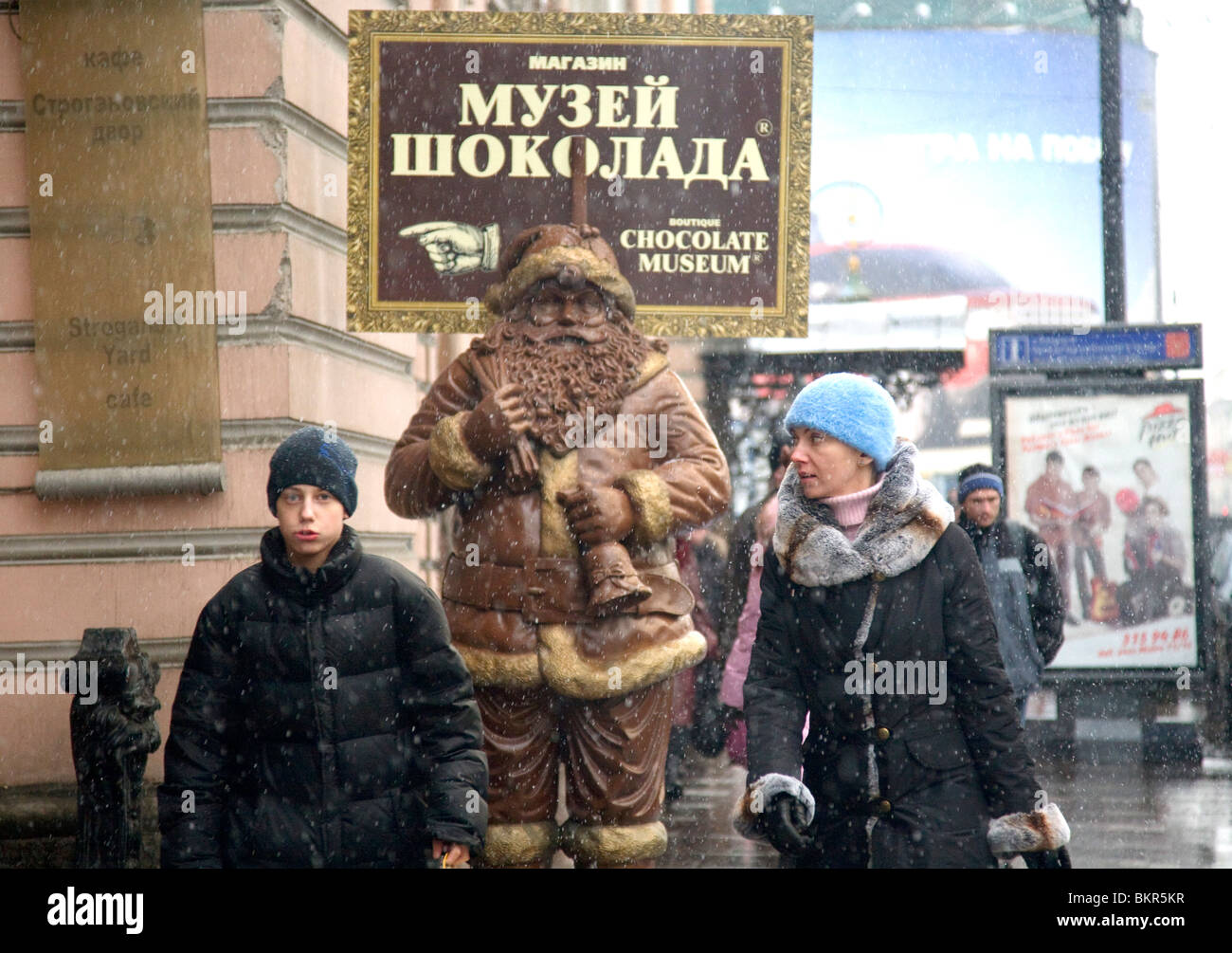 Russia, St.Petersburg; Walking acoss Nesky Prospekt, with a father Christmas advertising the chocolate museum Stock Photo