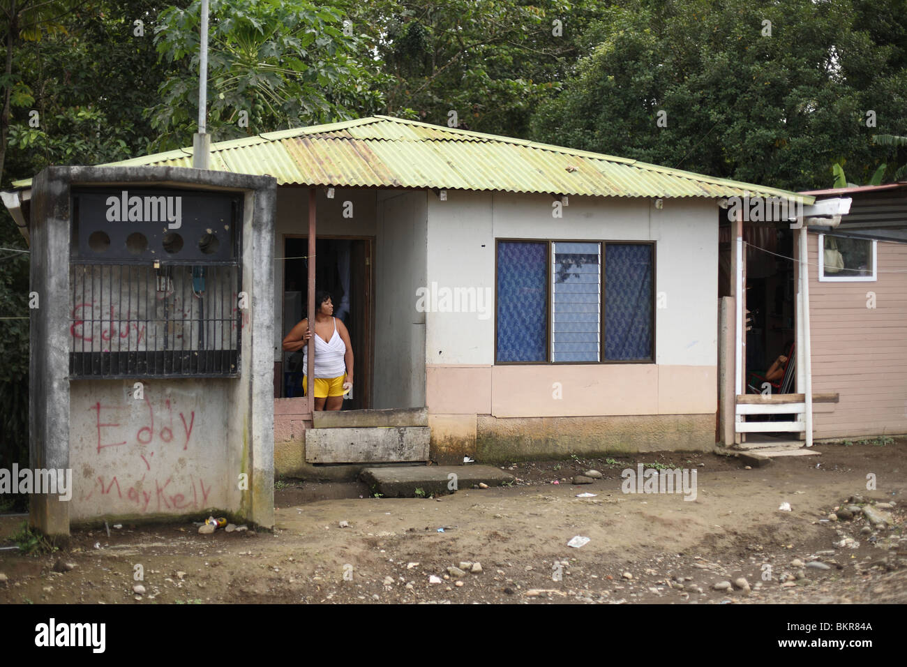 Costa Rican woman standing in front of her house. Stock Photo