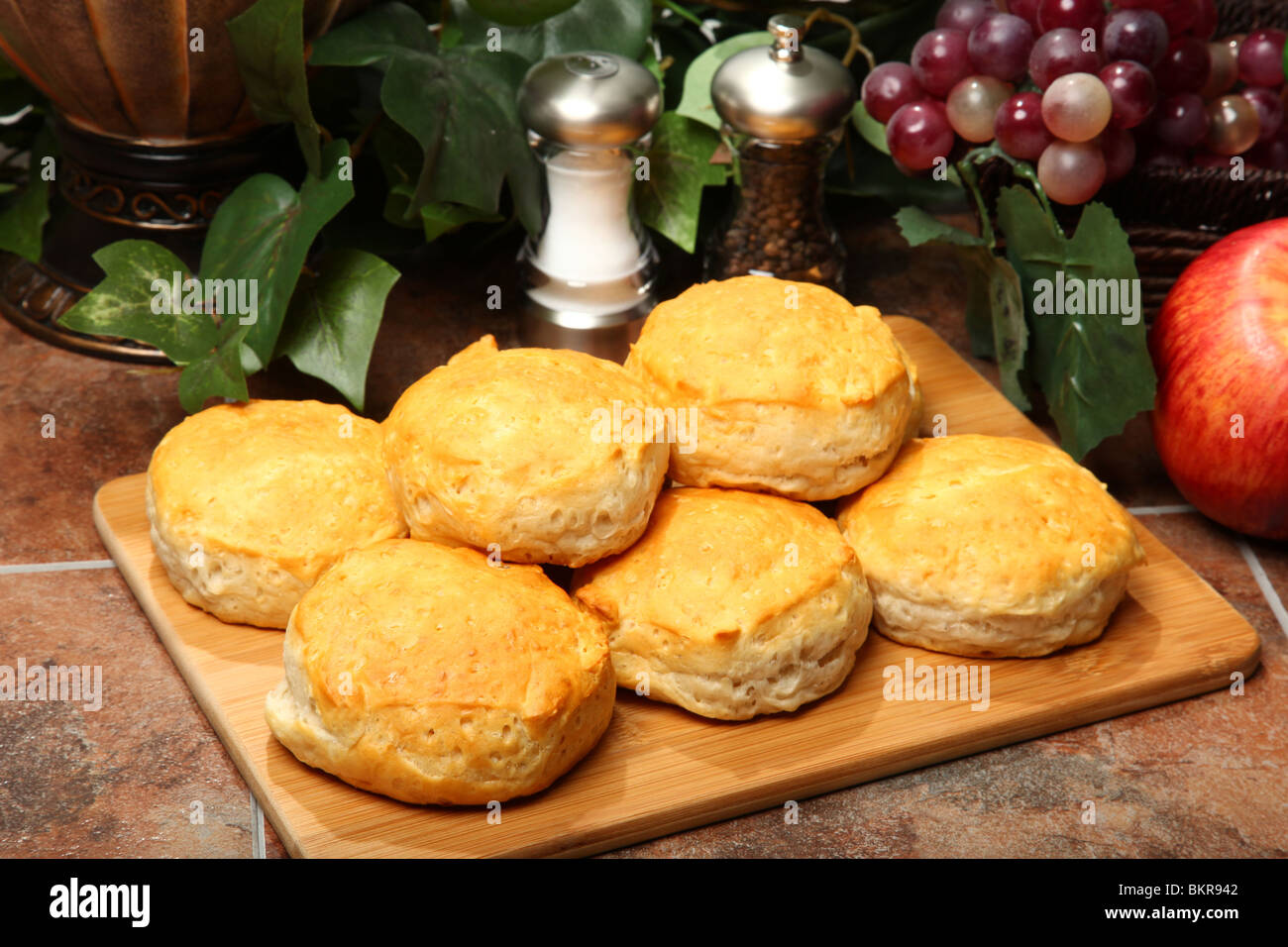 Stack Of Hot Fresh Breakfast Biscuits On Cutting Board In Kitchen