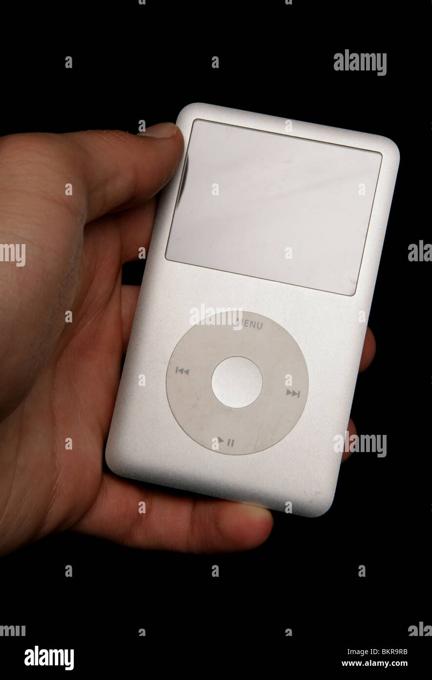 adult holding an Ipod mp3 player studio cutout Stock Photo Alamy