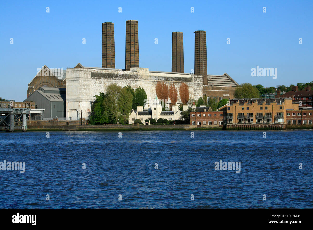 Seventeenth Century Trinity Hospital Greenwich overshadowed by Greenwich Power station, 4 chimneys tower above the building. Stock Photo