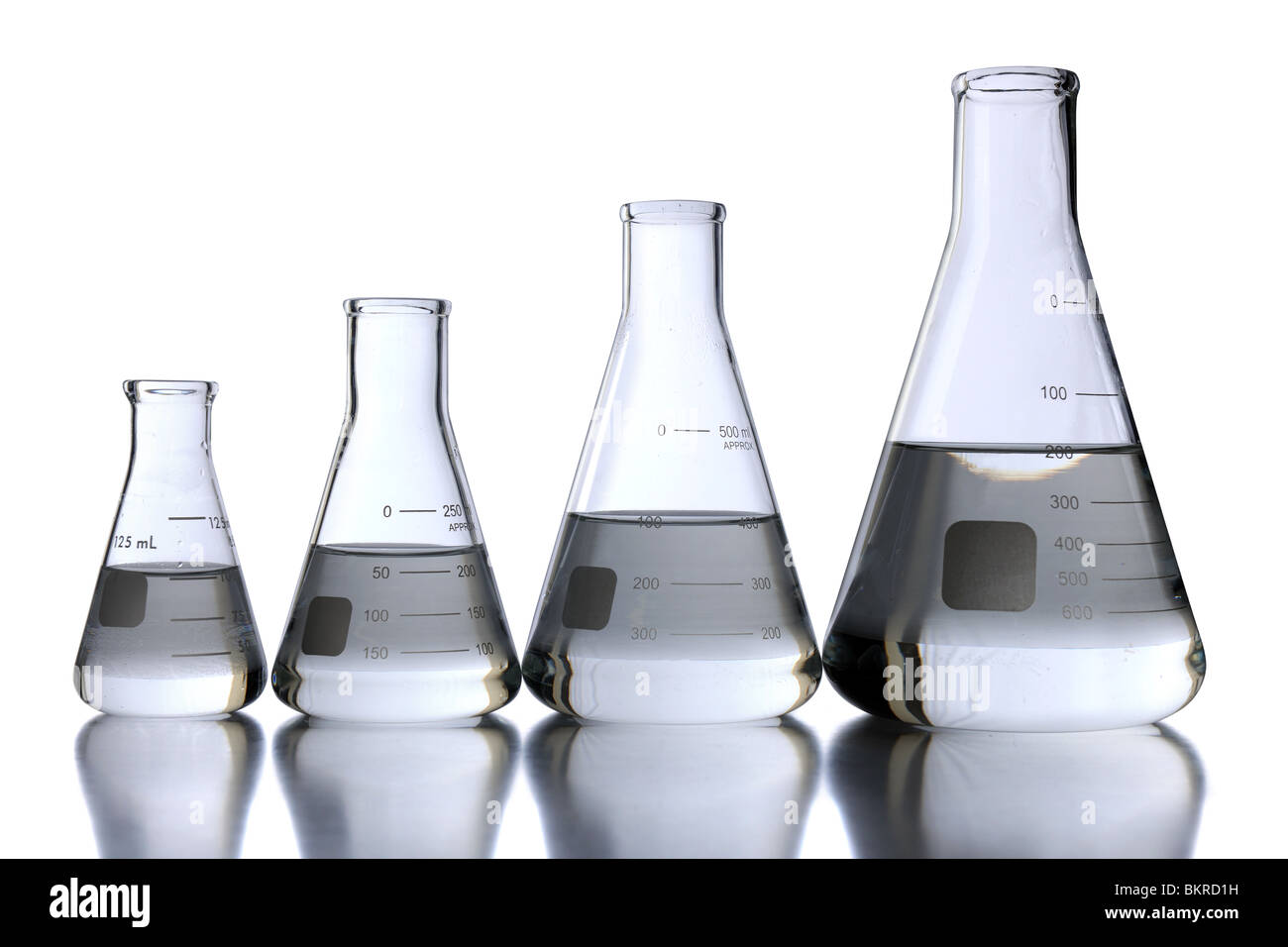 Laboratory flasks of different sizes over white background With