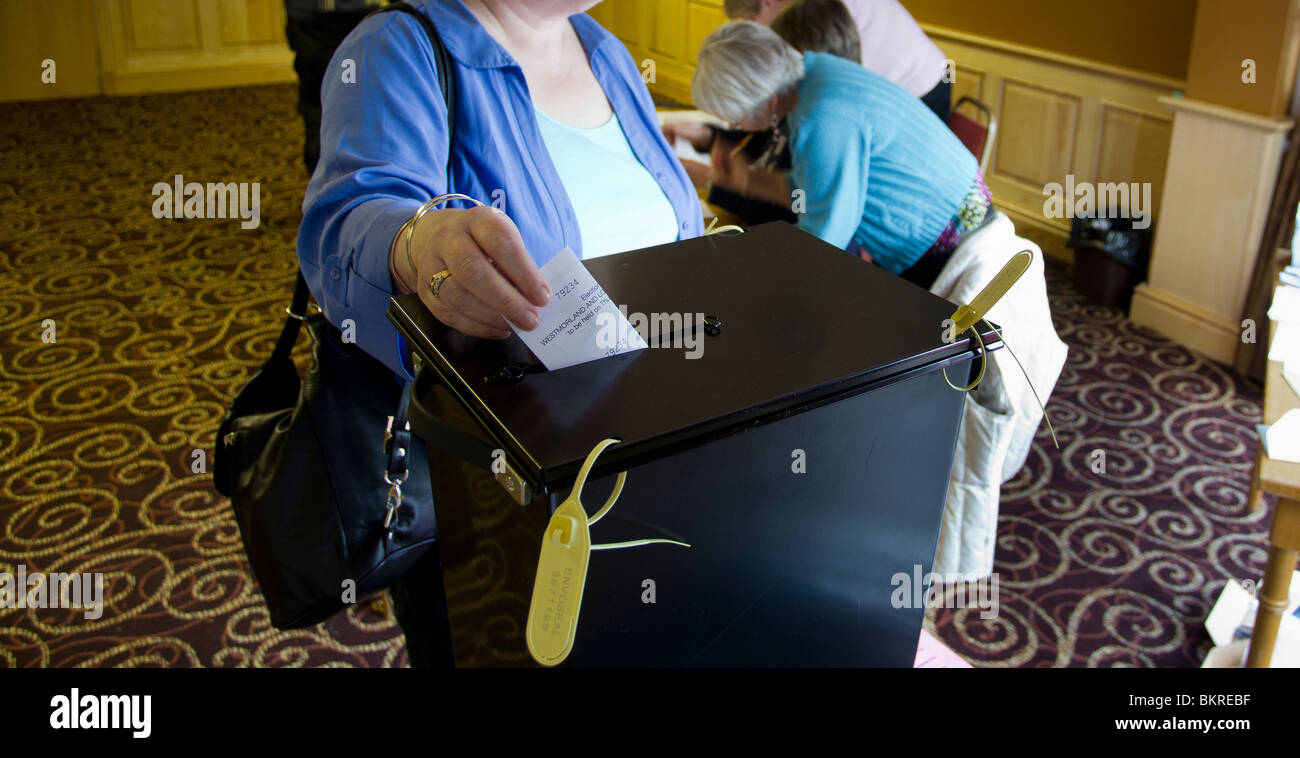 Voting General Election May 6th 2010 hand placing a vote into a  voting ballot box Stock Photo