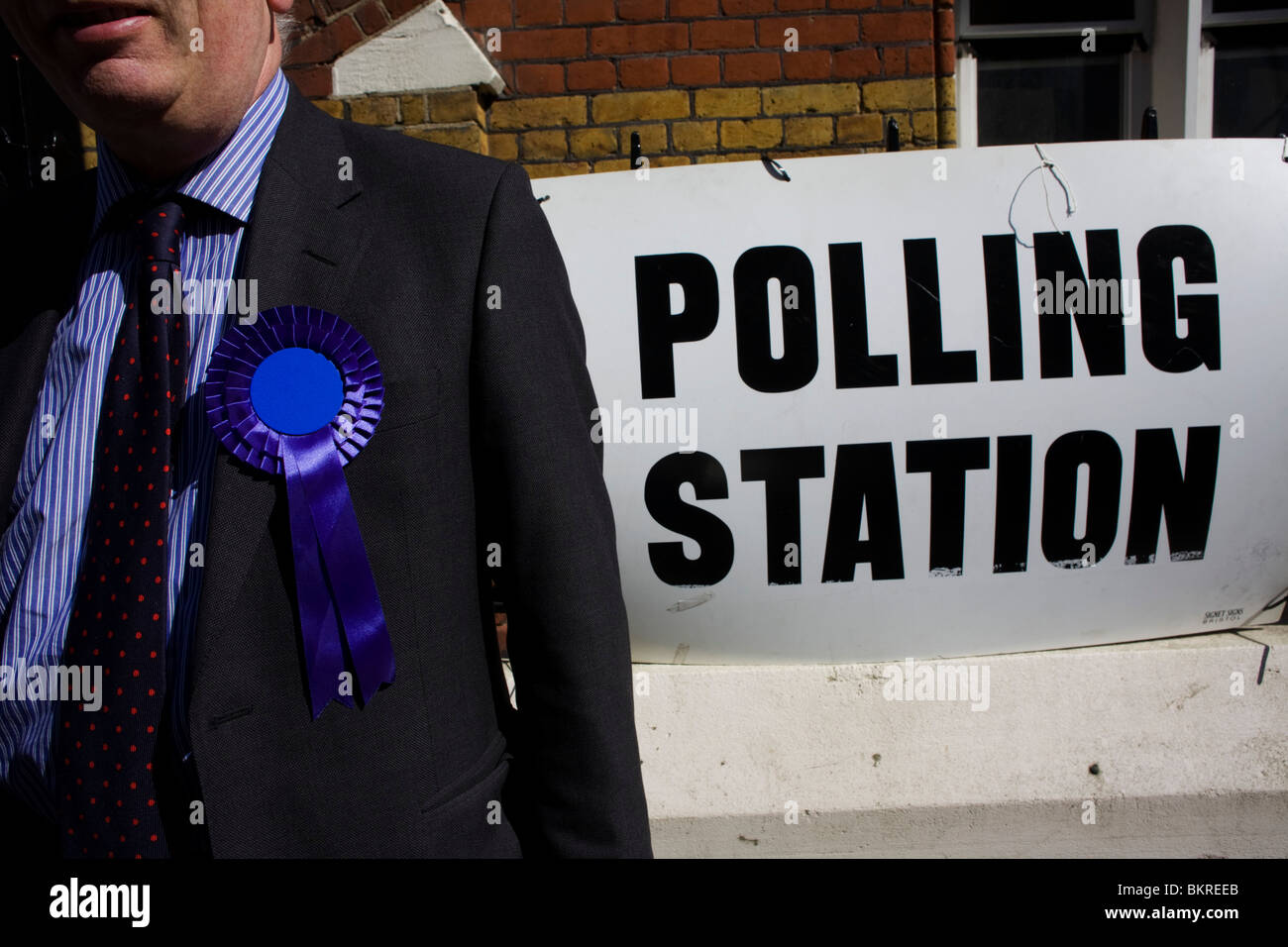 A Conservative Party teller outside temporary polling station at St Peter's Primary School Stock Photo