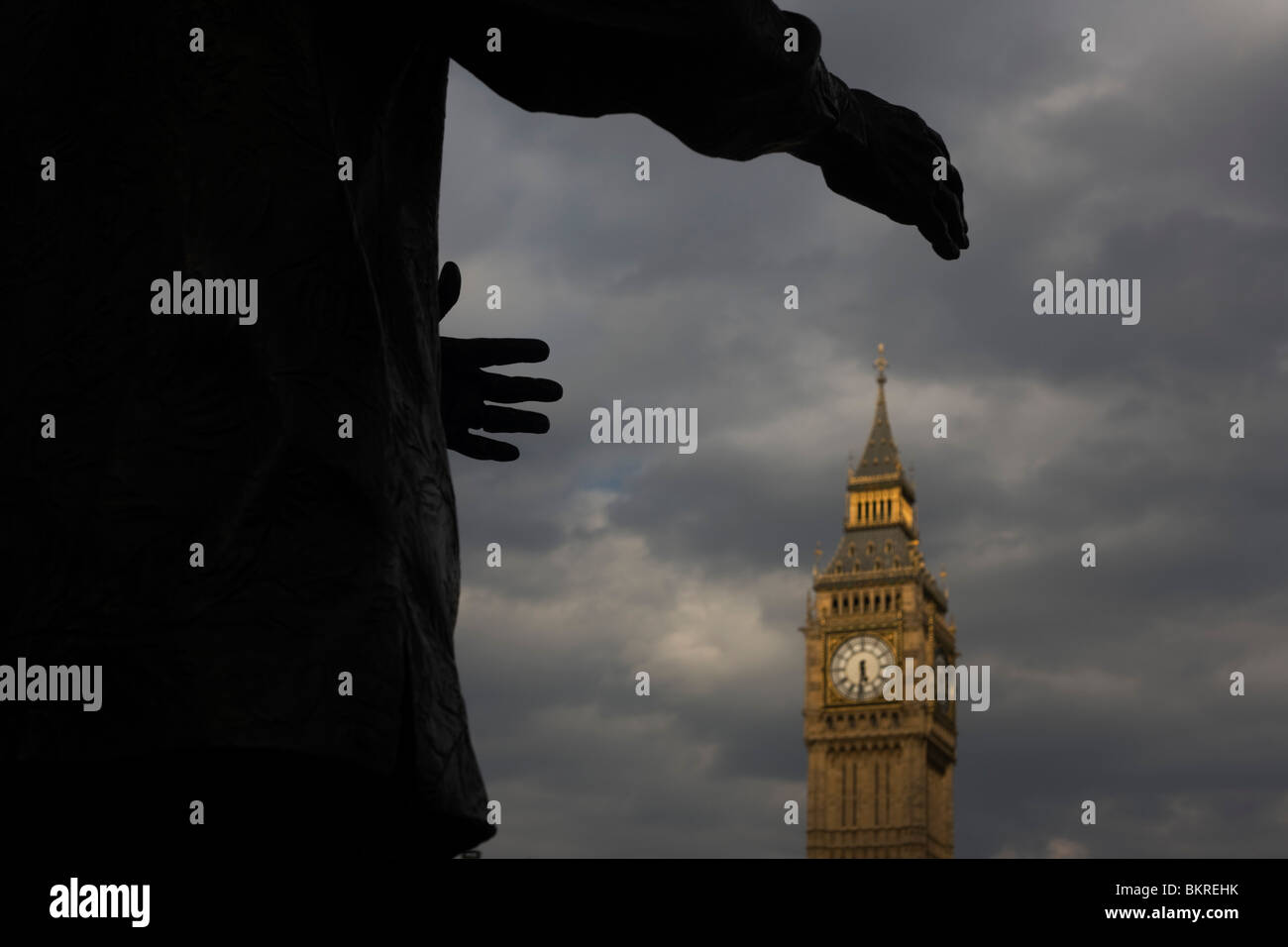 Hands of Nelson Mandela's statue appears to reach for Elizabeth Tower, a symbolic grasp for British political power. Stock Photo