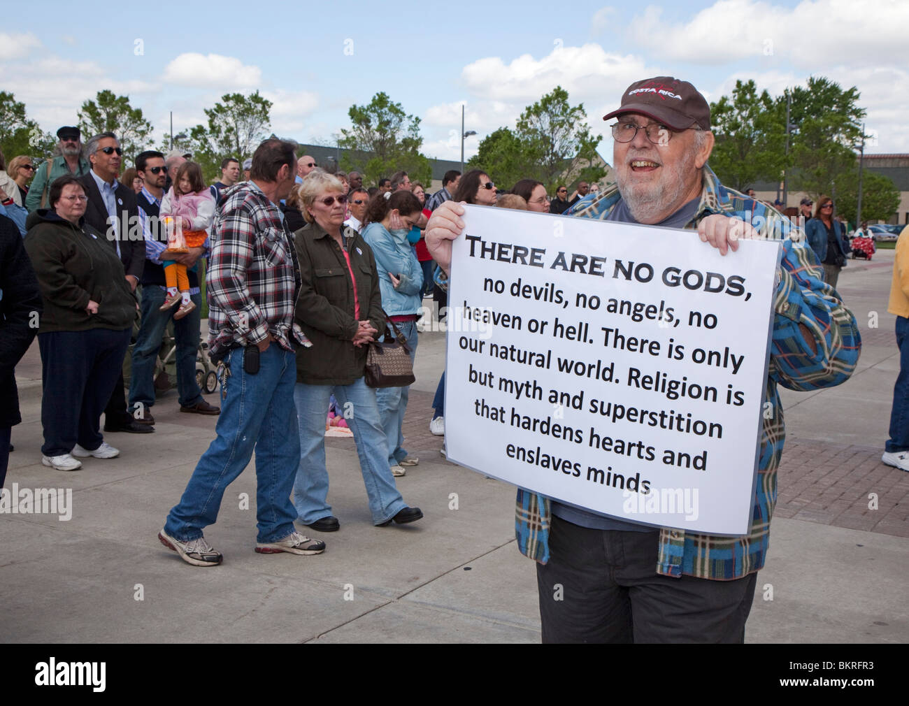 Warren, Michigan - A dissenter carries a sign denouncing religion during a National Day of Prayer observance at City Hall. Stock Photo