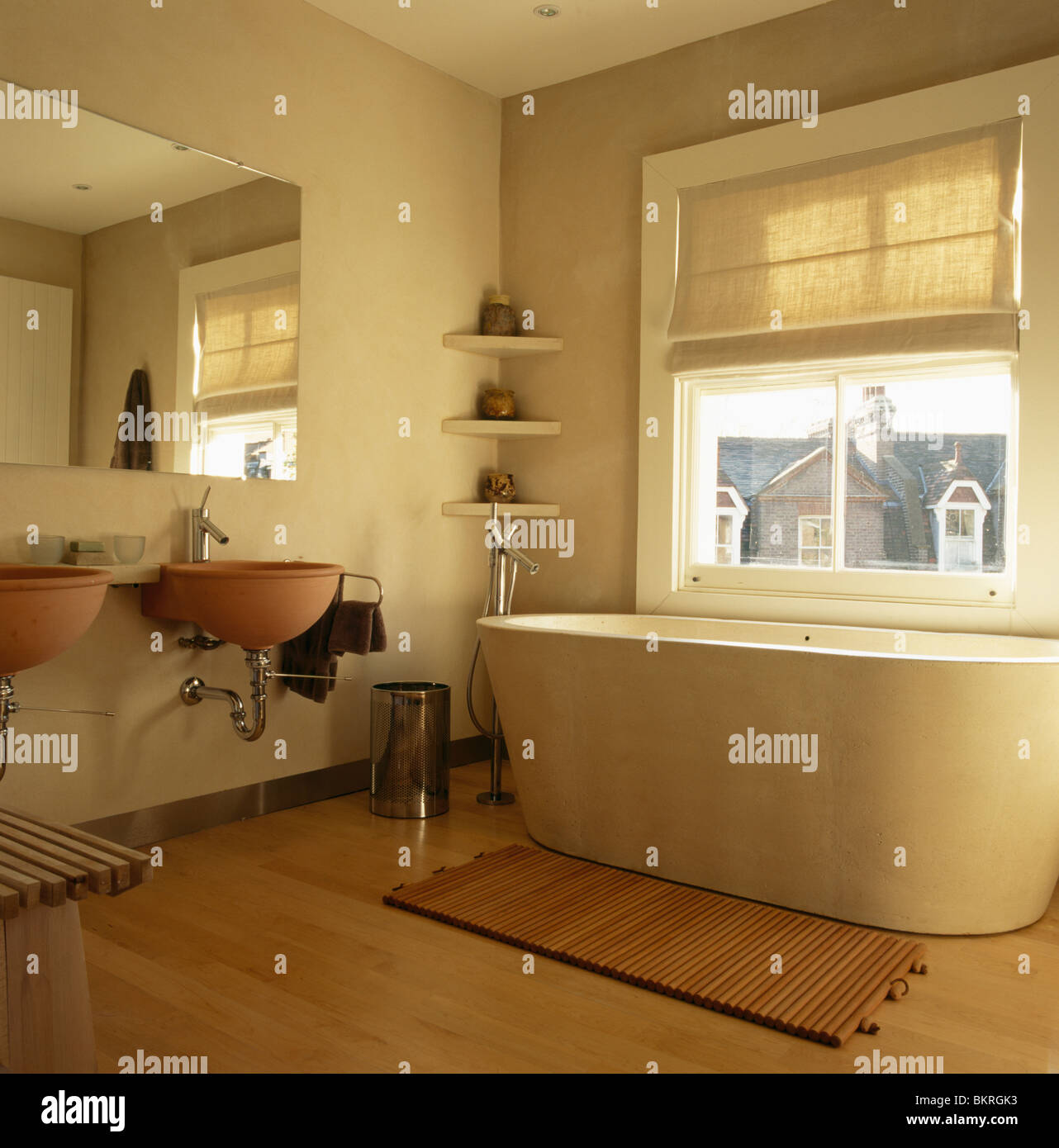 Large mirror above Philippe Starck double basins in modern bathroom