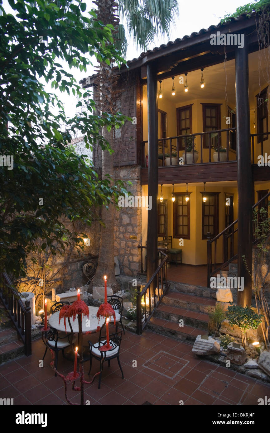 Evening by candelight courtyard of rooms at the Alp Pasha Hotel in Antalya old city Stock Photo