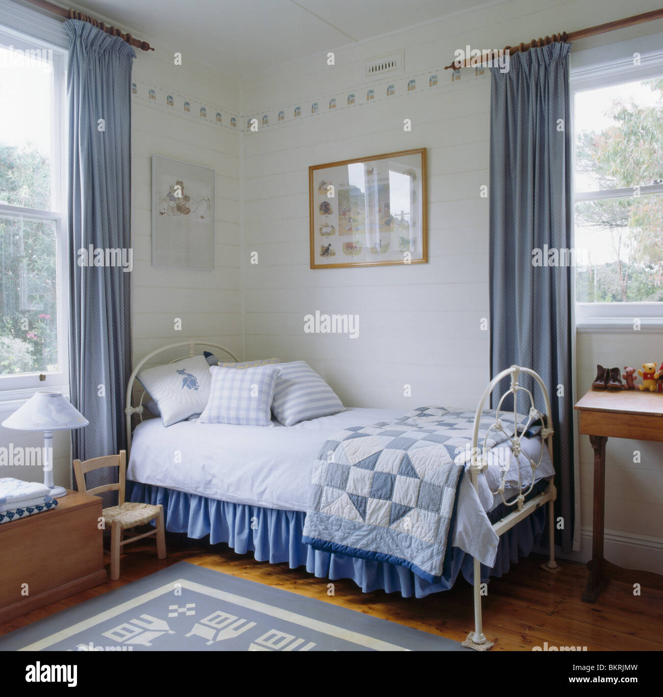 Blue Patchwork Quilt And White Linen On White Wrought Iron