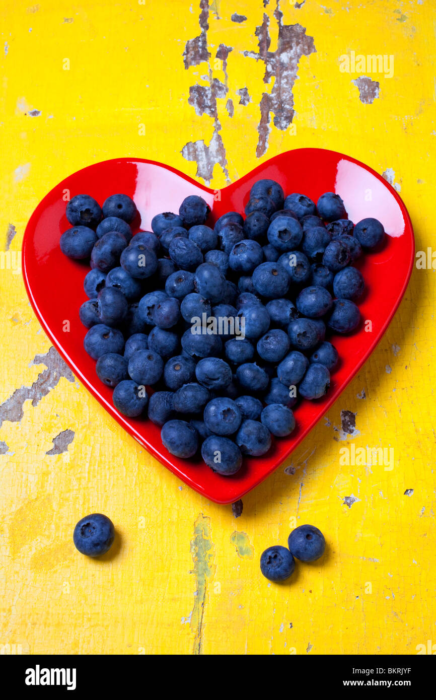 Red heart plate with blueberries Stock Photo