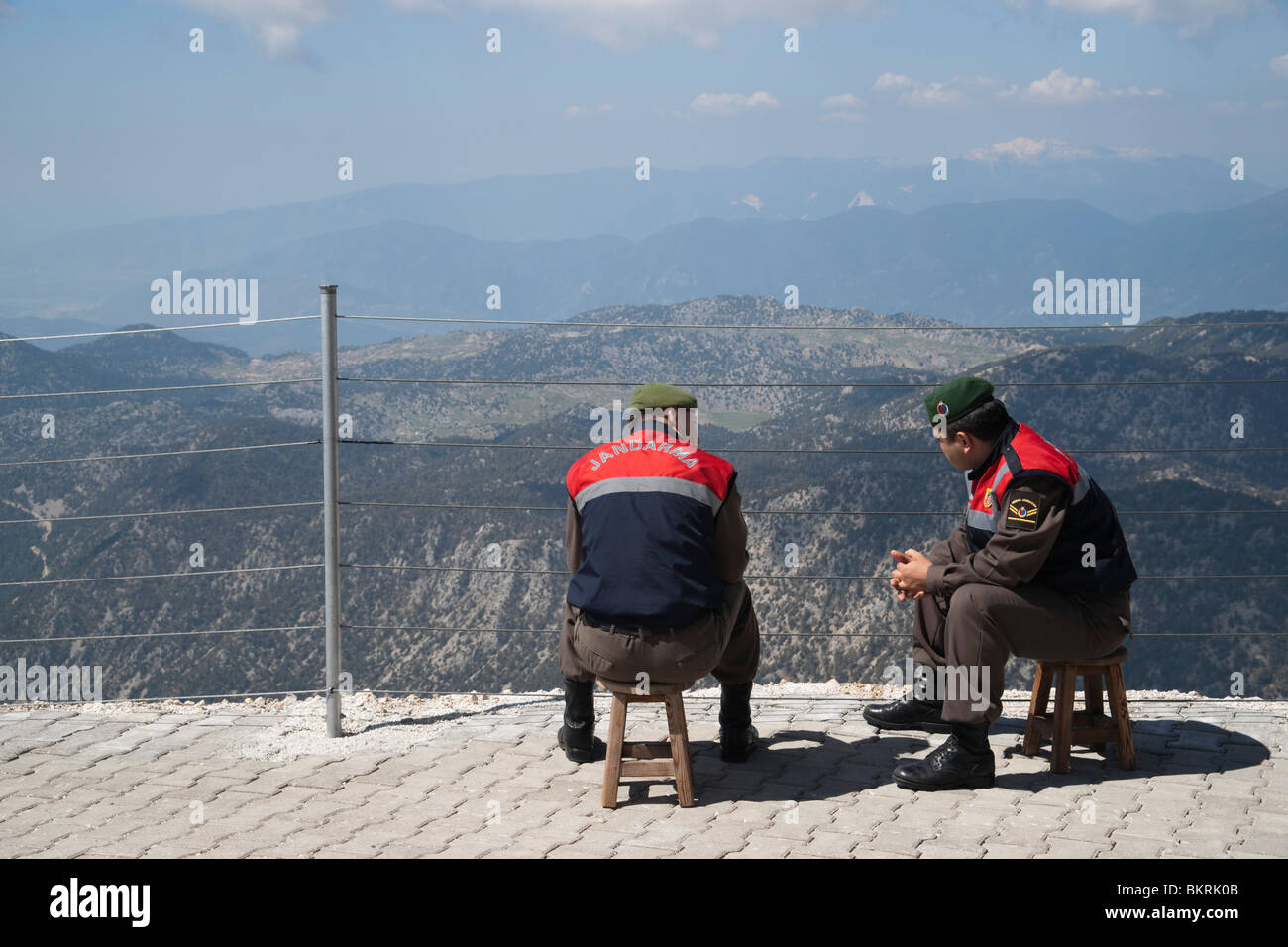 Turkish jendarms or armed police relax at the summit of Mount Tahtali after accompanying tourists using the cable car Stock Photo