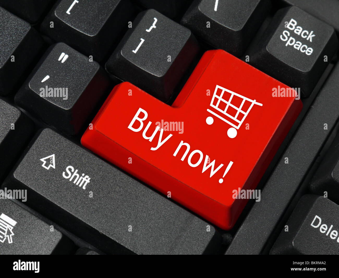 Closeup of red computer keyboard key with shopping cart symbol and Buy Now text Stock Photo