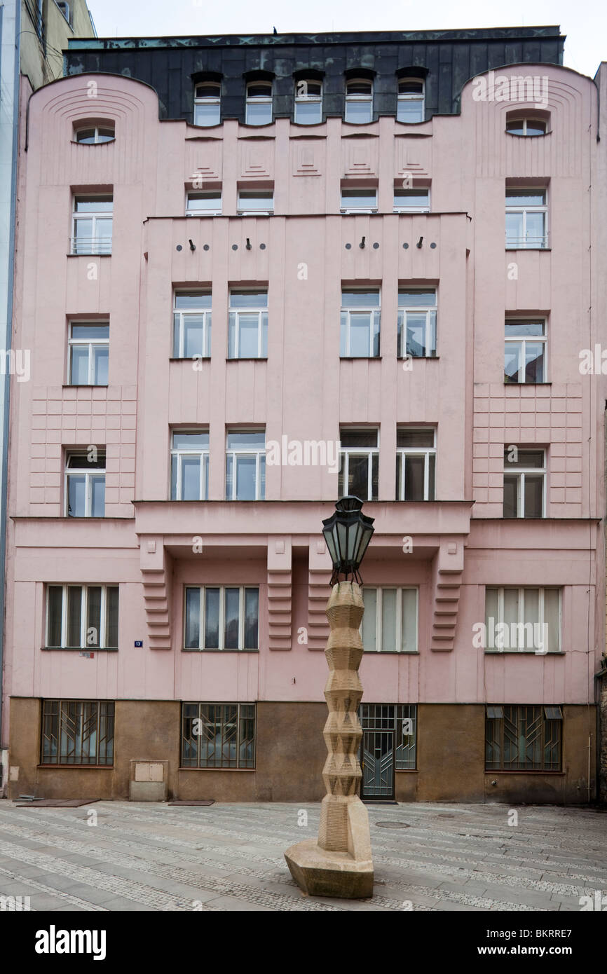 cubist style street lamp in front of art nouveau building, Prague