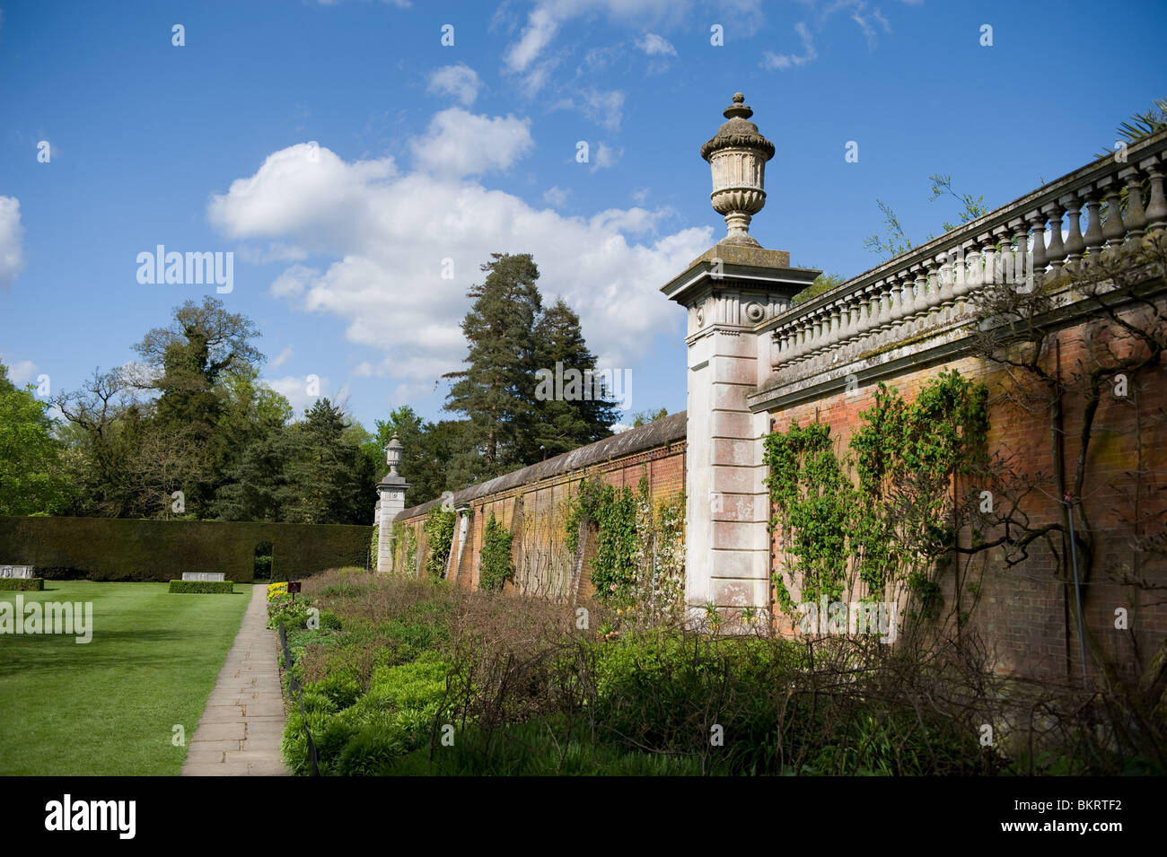 Ornamental wall with herbaceous border in mid-growth at Cliveden House, Buckinghamshire, UK Stock Photo